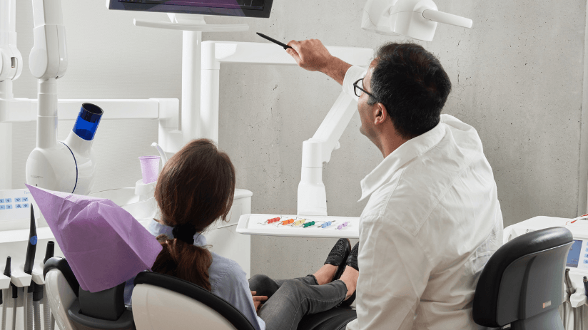 Dentist in West Sussex showing a patient her x-rays at a private dental practice
