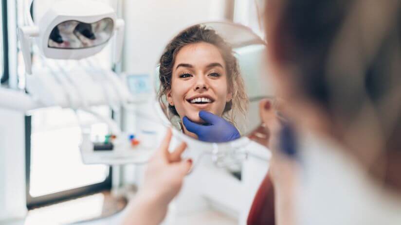 Woman having help with her oral hygiene concerns at Woodcroft Dental