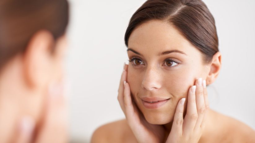 woman looking in the mirror after anti-wrinkle treatment